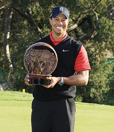 Tiger Woods poses with the trophy after winning the Chevron World Challenge