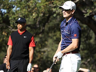 Tiger Woods and Zach Johnson watch Johnson's tee shot on the sixth tee box