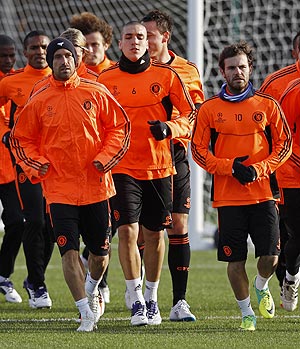 Chelsea players warm up before a training session in London on Monday