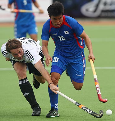 Sik Hyo You of Korea is challenged by Florian Fuchs of Germany (left)