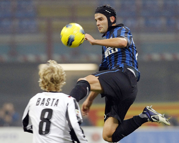 Inter Milan's Cristian Chivu (R) fights for the ball with Udinese's Dusan Basta in the Italian Serie A match at the San Siro in Milan