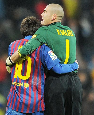 Goalkeeper Victor Valdes (right) of FC Barcelona celebrates with his team-mate Lionel Messi