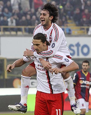 AC Milan's Zlatan Ibrahimovic celebrates with teammate Alberto Aquilani (top) after scoring a penalty against Bologna during their Serie A match on Sunday