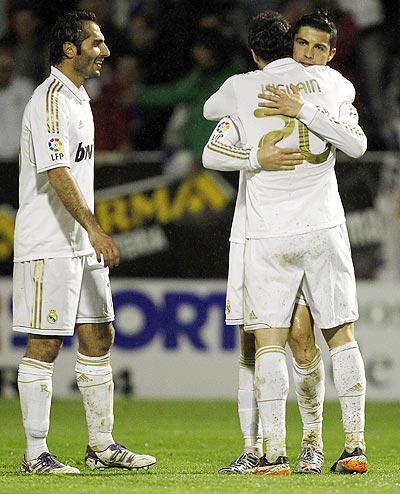 Cristiano Ronaldo (right) of Real Madrid celebrates after scoring with Gonzalo Higuain and Hamit Altintop (left)