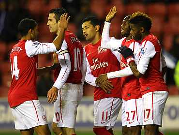 Arsenal players celebrate after scoing a goal