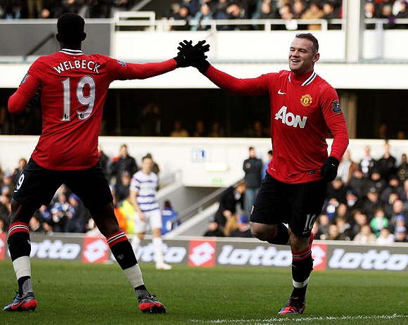 Wayne Rooney (right) celebrates with teammate Danny Welbeck after against QPR