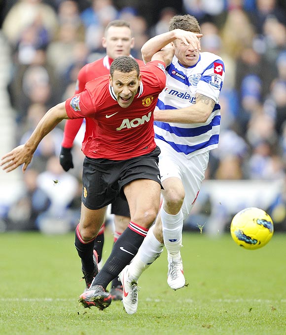Queens Park Rangers' Heidar Helguson (right) and Manchester United's Rio Ferdinand  fight for the ball