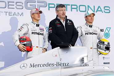 Mercedes F1 Team Principal Ross Brown, drivers Nico Rosberg and Michael Schumacher pose behind the MGP W02 during the presentation of the 2011 Mercedes F1 team in Cheste