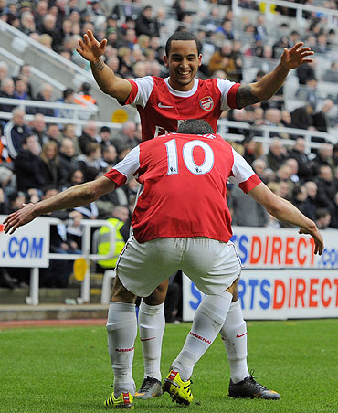 Arsenal's Robin Van Persie (10) celebrates with Theo Walcott after scoring against Newcastle United on Saturday
