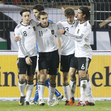 Germany's Miroslav Klose (2nd L) celebrates a goal against Italy with teammates Mesut Oezil (L), Thomas Muller (2nd R) and Sami Khedira (R) during their international friendly in Dortmund