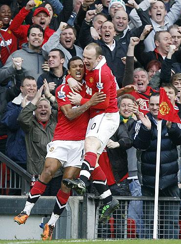 Nani celebrates with Wayne Rooney (right) after scoring against Man City