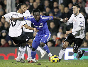 Chelsea's Michael Essien (centre) is challenged by Fulham's Moussa Dembele (left) and Clint Dempsey during their EPL match at Craven Cottage in London on Monday