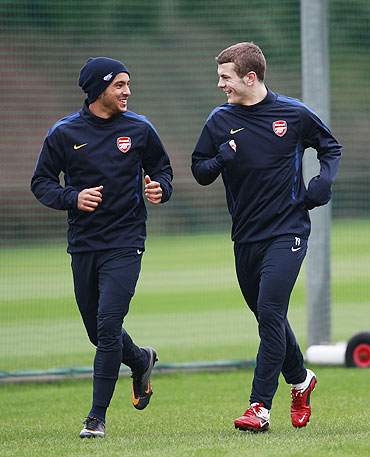 Arsenal's Theo Walcott (left) and Jack Wilshere attend a team training session in London Colney on Tuesday