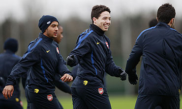 Arsenal's Samir Nasri (centre), Cesc Fabregas (right) and Theo Walcott attend a team training session in London Colney on Tuesday