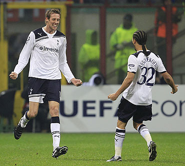 Tottenham Hotspur's Peter Crouch (left) celebrates with teammate Benoit Assou-Ekotto after scoring against AC Milan on Tuesday