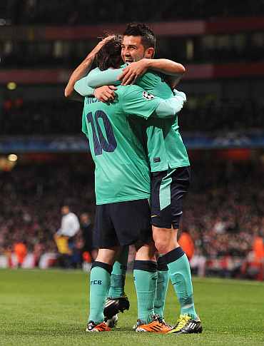 Barcelona's David Villa celebrates with Lionel Messi during his match against Arsenal at the Emirates