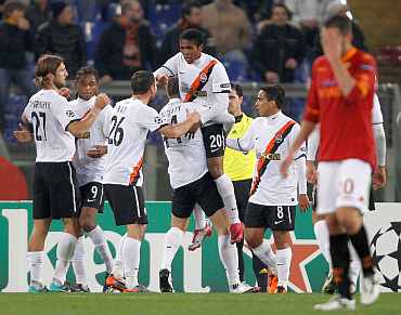 Shakhtar Donetsk players celebrate after scoring a goal during their match against AS Roma during their Champions League match at the Olympic stadium in Rome