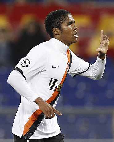 Shakhtar Donetsk's Douglas Costa celebrates after scoring against AS Roma during their Champions League match at the Olympic stadium