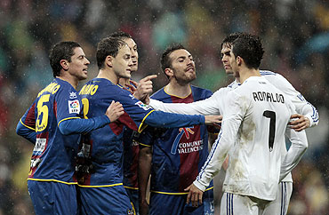 Levante's Asier del Horno (left), Victoriano Rivas, Sergio Ballesteros and Xavier Torres argue with Real Madrid's Cristiano Ronaldo (right) as Kaka tries to seperate them during their La Liga match at Santiago Bernabeu in Madrid on Saturday