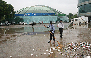A sweeper sweeps outside the Talkatora Boxing Stadium in New Delhi