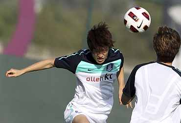 South Korea's Lee Chung-young heads the ball during a training session ahead of the Asian Cup