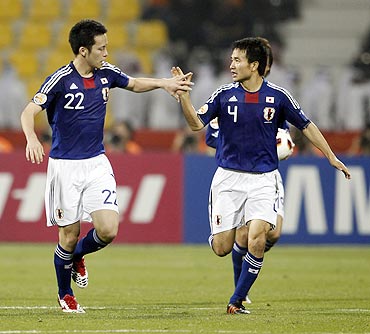 Japan's Maya Yoshida (left) celebrates his goal against Jordan with teammate Yasuyuki Konno