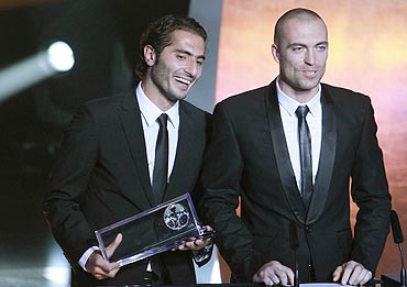 Hamit Altintop (left) of Turkey receives the FIFA Puska Award 2010 from goalkeeper Andrei Sidelnikov of Kazakhstan during the FIFA Ballon D'Or ceremony
