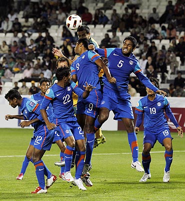 Indian players try to block a Tim Cahill header during their Asian Cup match against Australia on Monday