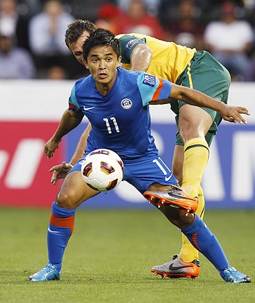 India's Sunil Chhetri holds off the challenge of Australia's Lucas Neill during their Asian Cup match on Monday
