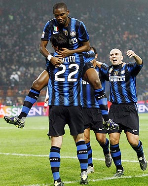 Inter Milan's Samuel Eto'o (top) celebrates with teammates after scoring against Bologna on Saturday