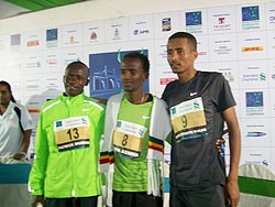 Aseefa (No 8) is flanked by Muriki (No 13) Wolde at the victory ceremony