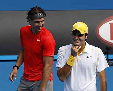 Rafa Nadal and Roger Federer look on during a Rally for Relief tennis match in Melbourne