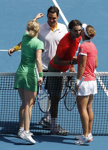 Rafael Nadal (2nd R), Roger Federer,  Sam Stosur (R) and Kim Clijsters (L) embrace at the Rally for Relief tennis match in Melbourne