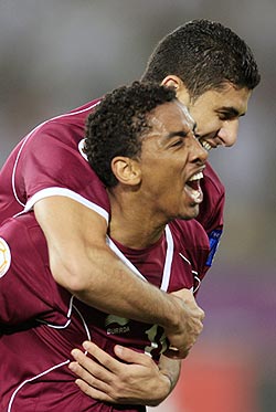 Qatar's Mohamed El Sayed (front) celebrates with teammate Yusef Ahmed after scoring against Kuwait on Sunday