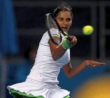 Sania Mirza returns to Justine Henin during her match at the Australian Open