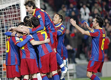 Barcelona's players celebrate Pedro's goal against Racing Santander