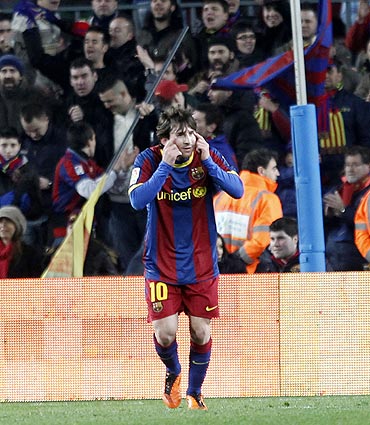 Barcelona's Lionel Messi celebrates his goal against Racing Santander
