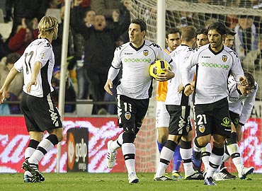 Valencia's Roberto Soldado (2nd from left) celebrates with teammates after scoring against Malaga
