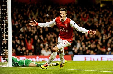 Arsenal's Robin Van Persie celebrates after his third goal against Wigan Athletic