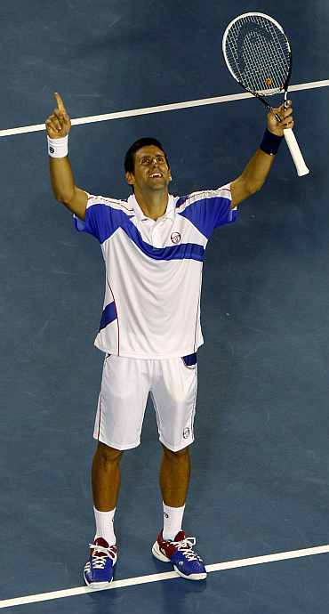 Novak Djokovic celebrates after winning the match against Roger Federer on Thursday