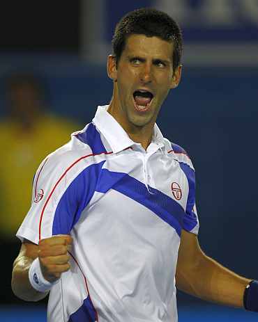 Novak Djokovic celebrates after winning a match against Roger Federer