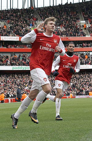 Arsenal's Nicklas Bendtner (left) celebrates his goal against Huddersfield on Sunday