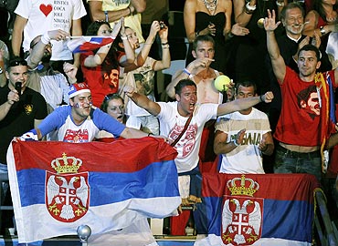 Serbia supporters celebrate in the stands after Novak Djokovic defeated Andy Murray on Sunday