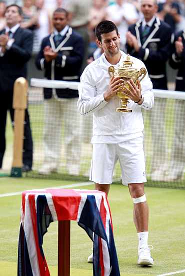 Novak Djokovic lifts the trophy after winning his final against Rafael Nadal