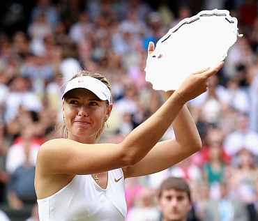 Maria Sharapova hold up her second place thropy after losing her Ladies' final round match against Petra Kvitova