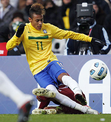 Brazil's Neymar clears the ball as Venezuela's Gabriel Cichero challenges during their Copa America soccer match in La Plata on Sunday