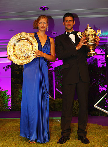Novak Djokovic of Serbia and Petra Kvitova of Czech Republic hold their winners trophies at the Wimbledon Championships 2011 Winners Ball on Sunday