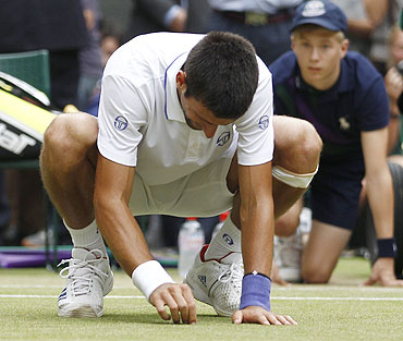 Novak Djokovic plucks the grass from the turf to eat it after beating Rafael Nadal in the men's single final at the Wimbledon on Sunday