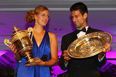 Novak Djokovic and Petra Kvitova swap their respective trophies at the Wimbledon Championships 2011 Winners Ball on Sunday