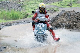A rider negotiates water-logged terrain during last year's rally